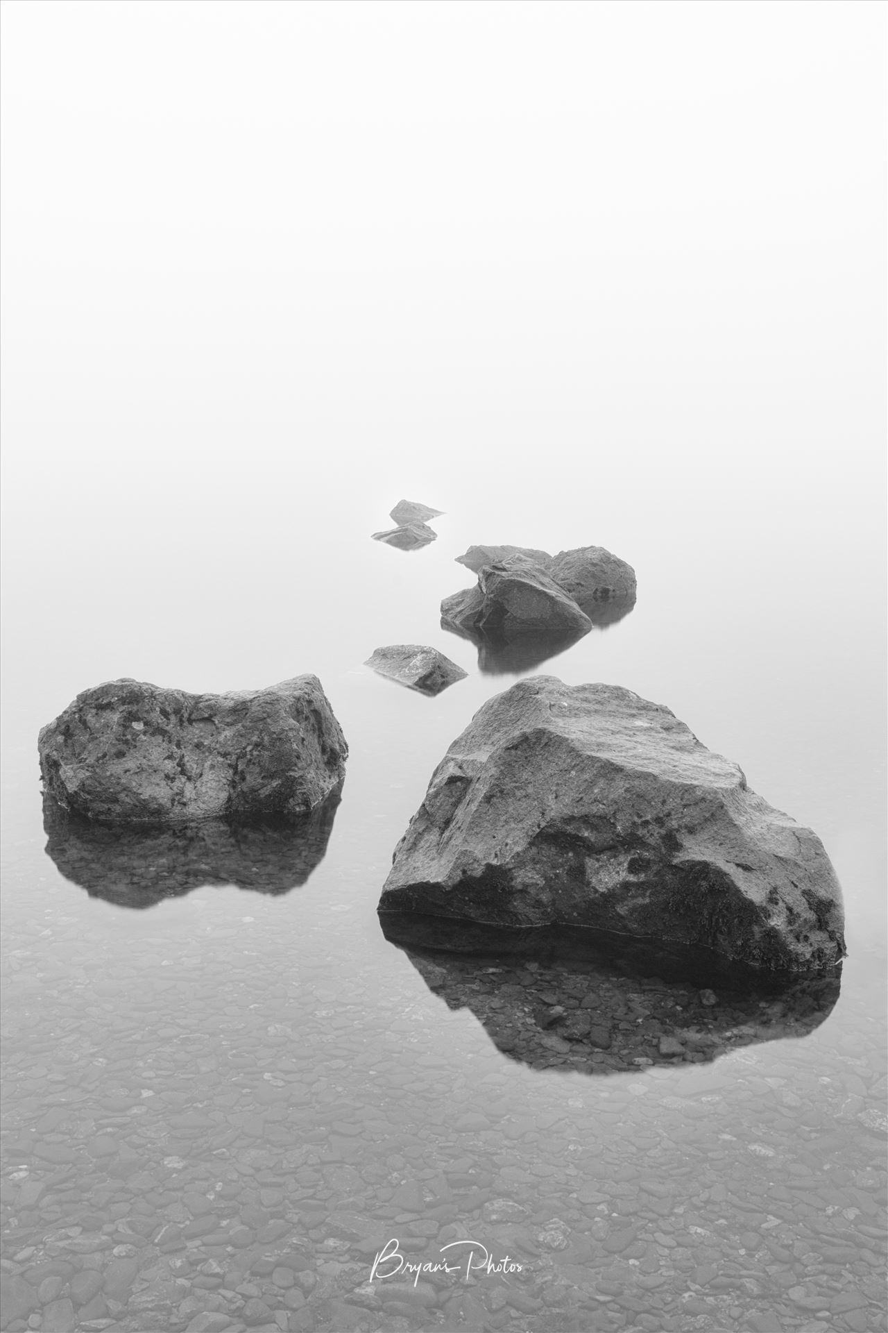 Milarrochy Rocks A black and white photograph of the rocks at Milarrochy Bay Loch Lomond. by Bryans Photos