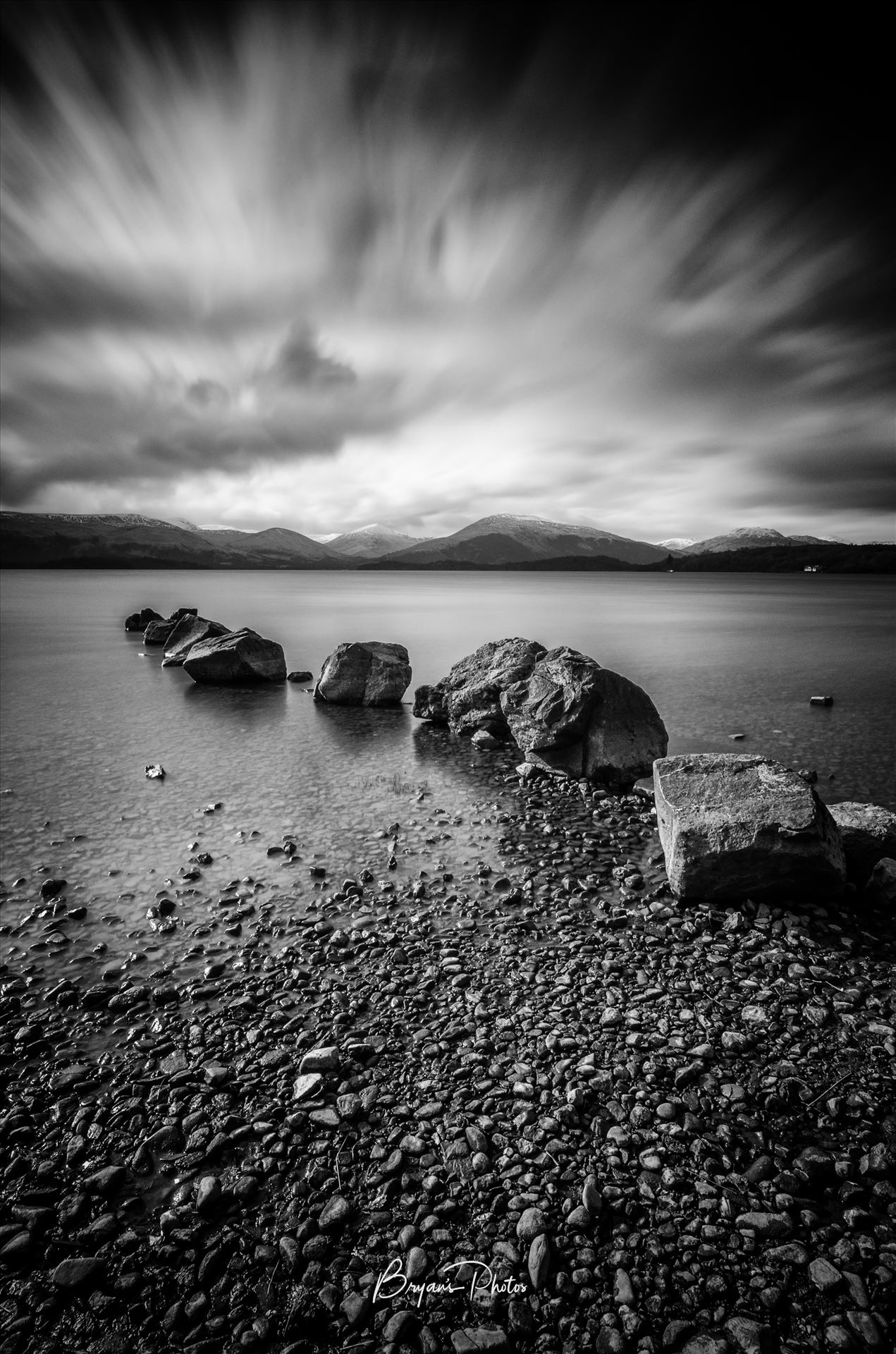 Milarrochy Bay A black and white long exposure photograph of Loch Lomond taken from Milarrochy Bay. by Bryans Photos