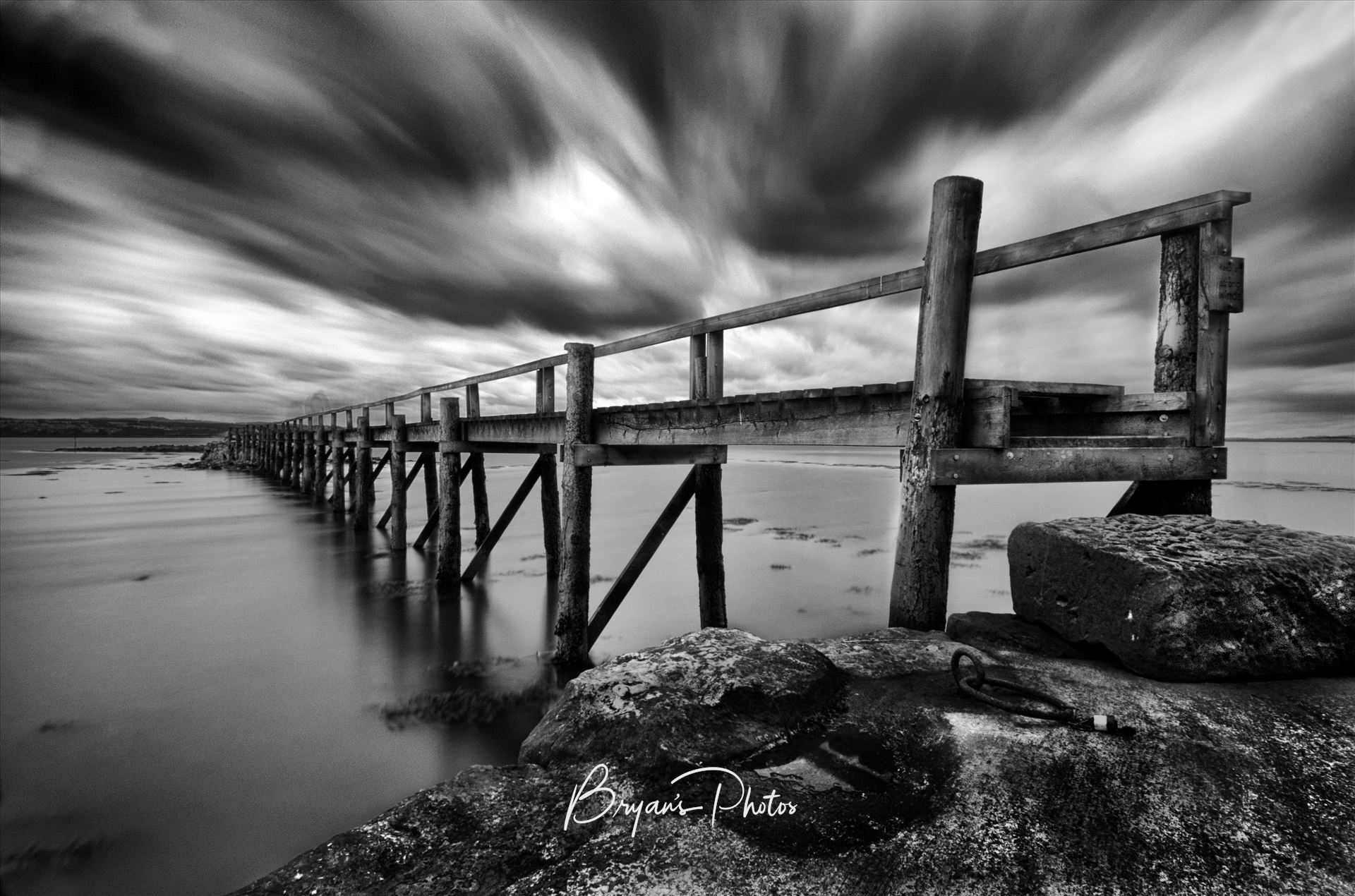 Historic Pier at Culross A black and white photograph of the historic pier at Culross on the Fife Coast. Culross harbour is one of the oldest in Scotland and the pier is being restored to it's former state. by Bryans Photos