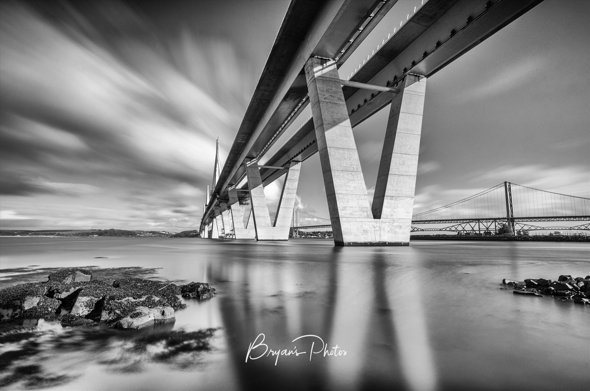 The Crossing A black and white long exposure photograph of the Queensferry Crossing taken from the south bank of the river Forth at high tide. by Bryans Photos