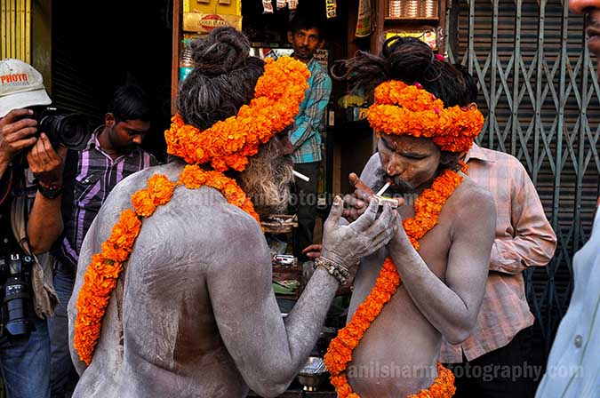 Culture- Naga Sadhu’s (India) Naga Sadhu’s  litting cigarette. by Anil Sharma Photography