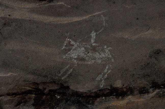 Archaeology- Bhimbetka Rock Shelters Prehistoric Rock Painting of a men riding horse in white color at Bhimbetka archaeological site by Anil Sharma Photography