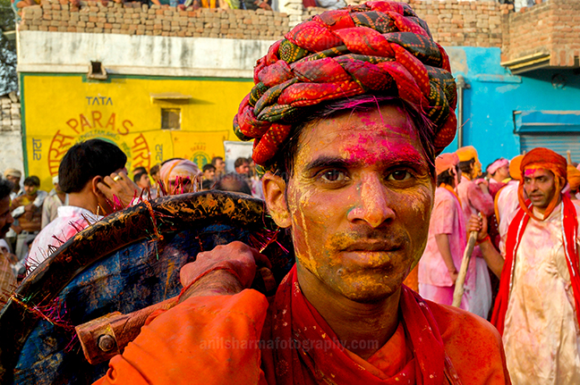 Festivals- Lathmaar Holi of Barsana (India) A man daubed in color powder smiles as he celebrates lathmaar Holi at Barsana. by Anil Sharma Photography