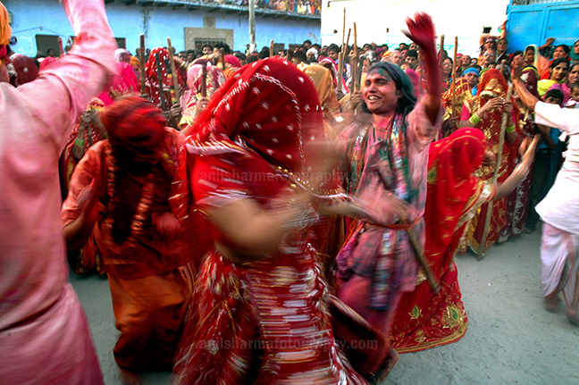 Festivals- Lathmaar Holi of Barsana (India) Some women dancing some holding bamboo sticks, during " Lathmaar Holi  at Nandgoan, Mathura, Uttar Pradesh, India. by Anil Sharma Photography