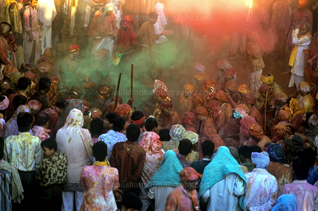 Festivals- Lathmaar Holi of Barsana (India) Large number of people gathered sprinkle colored powder, singing, dancing during Lathmaar Holi celebration at Barsana, Mathura, India. by Anil Sharma Photography