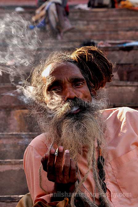 Culture- Naga Sadhu’s (India) A Naga Sadhu smoking  bidi at Varanasi ghat. by Anil Sharma Photography